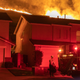 Flames come close to houses during the Blue Ridge Fire on Oct. 27, 2020 in Chino Hills, California.